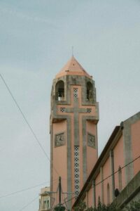 A serene view of a church tower in Póvoa de Varzim, Portugal, showcasing unique architecture.